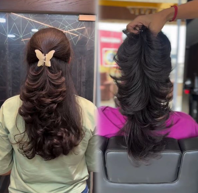 Long layered haircut styled with soft flowing curls, enhanced bounce, smooth texture and a voluminous salon finish