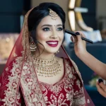 Indian bride receiving expert bridal makeup with detailed eye definition, smooth complexion and premium finish